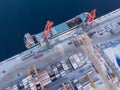 Commercial north arctic port is loading containers onto cargo tanker ship. Concept logistics and delivery of goods Royalty Free Stock Photo