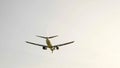 Commercial passenger airplane flying overhead on sunny day Royalty Free Stock Photo