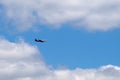 commercial passenger plane flies high in the blue sky with clouds Royalty Free Stock Photo