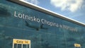 Airliner landing reflecting in the windows with Lotnisko w Warszawie or Warsaw Chopin Airport text. 3d rendering Royalty Free Stock Photo