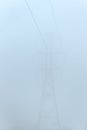 Commercial power lines and self-supporting tower on a very foggy day