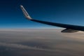 06/09/2021. Commercial Ryanair airborne airplane at high altitude. Cabin window view at wing with company name.