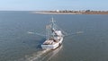 A commercial shrimping boat pulls nets off the cost of South Carolina Royalty Free Stock Photo