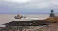 commercial tug boat going out to sea at battery point portishead uk