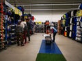 Commercial worker arranging the products and customers at Decathlon