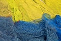 Commercial yellow and blue color fishing nets in port as background Royalty Free Stock Photo