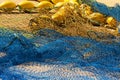 Commercial yellow and blue color fishing nets in port on the ground as background Royalty Free Stock Photo