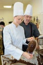 Commis chef prepares chocolate with chef checking Royalty Free Stock Photo