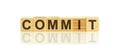 COMMIT word written on wood block, concept commitment