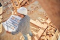 Committed builder checking blueprints of a house Royalty Free Stock Photo