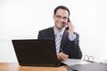 Committed employee with glasses smiling at phone Royalty Free Stock Photo