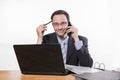 Committed employee with glasses smiling at phone Royalty Free Stock Photo