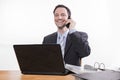 Committed employee smiling at phone Royalty Free Stock Photo