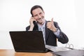 Committed employee smiling at phone thumbs up Royalty Free Stock Photo