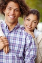 Committed to a loving future. Portrait of a beautiful mixed race couple smiling together outdoors. Royalty Free Stock Photo
