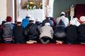 Committed to their faith. people worshipping in a mosque.