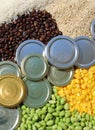commodity goods with coffee beans, metal lids, corn, full grain rice and soybeans commodity Royalty Free Stock Photo