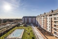 Common areas of an urbanization with swimming pools, benches and flower boxes and a lot of grass and tennis courts Royalty Free Stock Photo