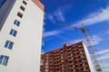 Common city building construction facade foreshortening from below perspective exterior urban view with crane industrial object on