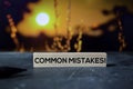 Common Mistakes! on the sticky notes with bokeh background