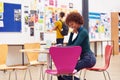 Communal Area Of Busy College Campus With Female Student Working At Table