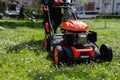 Communal services gardener worker man using lawn mower for grass cutting in city park Royalty Free Stock Photo