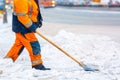 Communal services worker removes snow from road in winter, Cleaning city streets and roads during snowstorm. Moscow, Russia Royalty Free Stock Photo