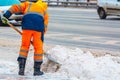 Communal services worker removes snow from road in winter, Cleaning city streets and roads during snowstorm. Moscow, Russia Royalty Free Stock Photo