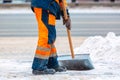 Communal services worker sweeps snow from road in winter, Cleaning city streets and roads after snow storm. Moscow, Russia Royalty Free Stock Photo