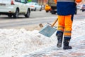 Communal services worker sweeps snow from road in winter, Cleaning city streets and roads during snowstorm. Moscow, Russia Royalty Free Stock Photo