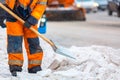 Communal services worker sweeps snow from road in winter, Cleaning city streets and roads during snowstorm. Moscow, Russia Royalty Free Stock Photo