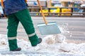 Communal services worker sweeps snow from road in winter, Cleaning city streets and roads during snowstorm. Moscow, Russia Royalty Free Stock Photo