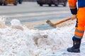 Communal services worker sweeps snow from road in winter, Cleaning city streets and roads during snowstorm. Moscow, Russia Royalty Free Stock Photo