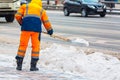 Communal services worker sweeps snow from road in winter, Cleaning city streets and roads during snowstorm. Moscow, Russia Royalty Free Stock Photo