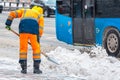 Communal services worker sweeps snow from road in winter, Cleaning city streets and roads during snowstorm. Moscow, Russia Royalty Free Stock Photo