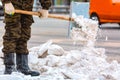 Communal services worker sweeps snow from road in winter, Cleaning city streets and roads during snowstorm. Moscow, Russia Royalty Free Stock Photo