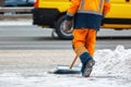 Communal services worker sweeps snow from road in winter, Cleaning city streets and roads after snow storm. Moscow, Russia