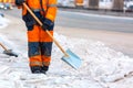 Communal services worker sweeps snow from road in winter, Cleaning city streets and roads after snow storm. Moscow, Russia Royalty Free Stock Photo