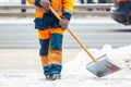 Communal services worker sweeps snow from road in winter, Cleaning city streets and roads after snow storm. Moscow, Russia Royalty Free Stock Photo