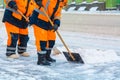 Communal services workers sweep snow from road in winter, Cleaning city streets and roads during snowstorm. Moscow, Russia Royalty Free Stock Photo