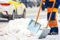 Communal services workers sweep snow from road in winter, Cleaning city streets and roads during snowstorm. Moscow, Russia Royalty Free Stock Photo