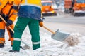 Communal services workers sweep snow from road in winter, Cleaning city streets and roads during snowstorm. Moscow, Russia Royalty Free Stock Photo