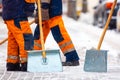 Communal services workers sweep snow from road in winter, Cleaning city streets and roads during snowstorm. Moscow, Russia Royalty Free Stock Photo