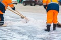 Communal services workers sweep snow from road in winter, Cleaning city streets and roads after snow storm. Moscow, Russia Royalty Free Stock Photo