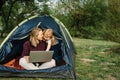 Communicate with relatives, family online on laptop in tent in nature. Woman worker speak talk on video call with colleagues. Royalty Free Stock Photo