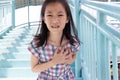 Communicates the symptoms of heart disease,immediately,Asian girl on the pedestrian overpass Royalty Free Stock Photo