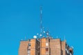 Communication antennas and satellite dishes on top of high residential building