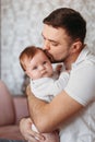 Communication of a beautiful young father with a newborn daughter in his arms Royalty Free Stock Photo