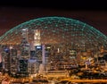 Communication connection network dome shaped above city skylilne at night