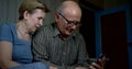 Communication by internet using smartphone, seniors are calling by video, sitting at home